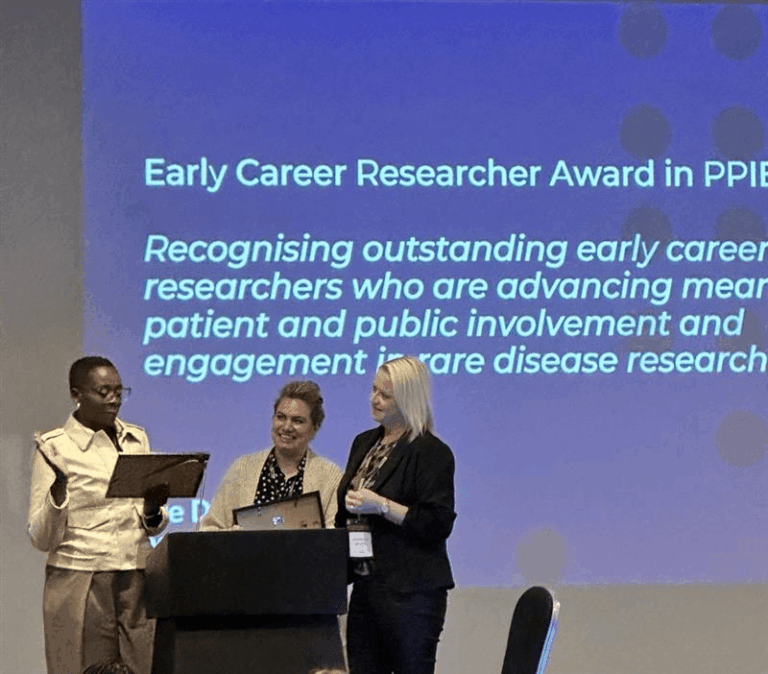 Kerry Leeson-Beevers presenting the award to Dr Aimee Walker-Clarke and Linda Fred at the ceremony.